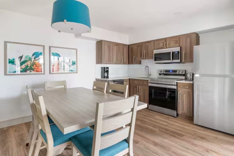 Share meals together at the table beside the modern kitchen.