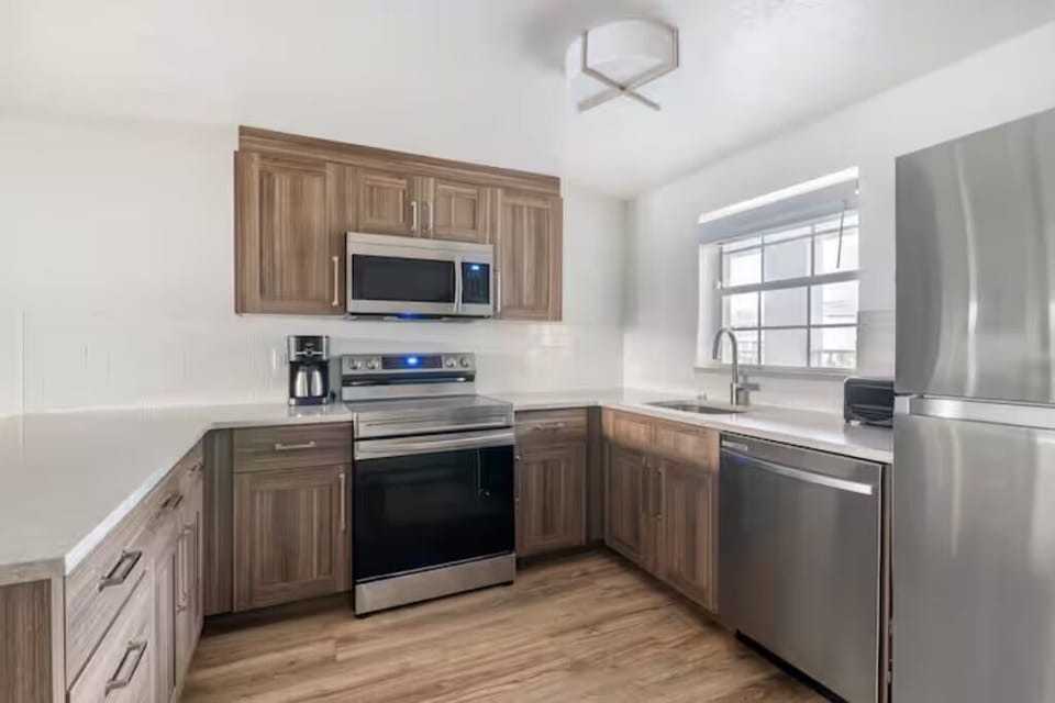 Cook with ease in a full kitchen with stainless appliances.