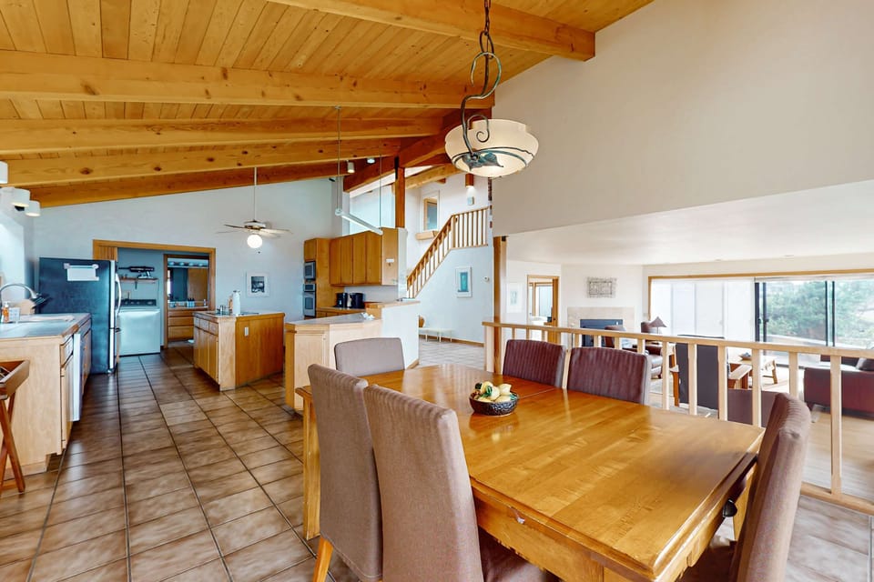 The open layout connects the dining area to the kitchen, making it easy to share laughter and delicious meals while soaking in the coastal vibes.