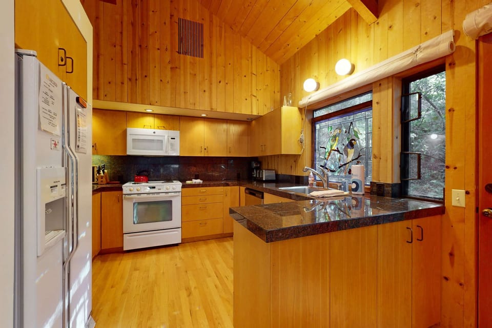 Unleash your inner chef in the modern kitchen, complete with ample counter space and all the essentials for crafting delicious meals together.