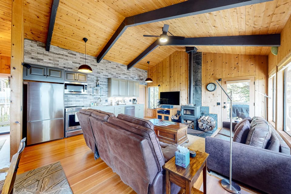 Gather in the cozy living room, where natural light dances off the rich wood accents, creating a warm and inviting space for family and friends.