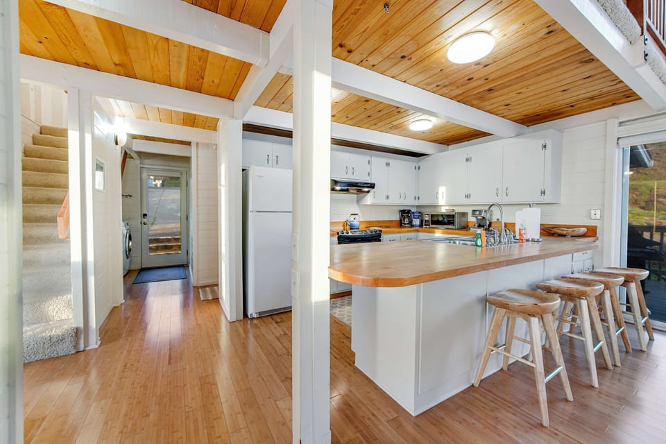 Create culinary delights in this spacious kitchen, designed for both cooking and socializing, while enjoying the coastal charm.