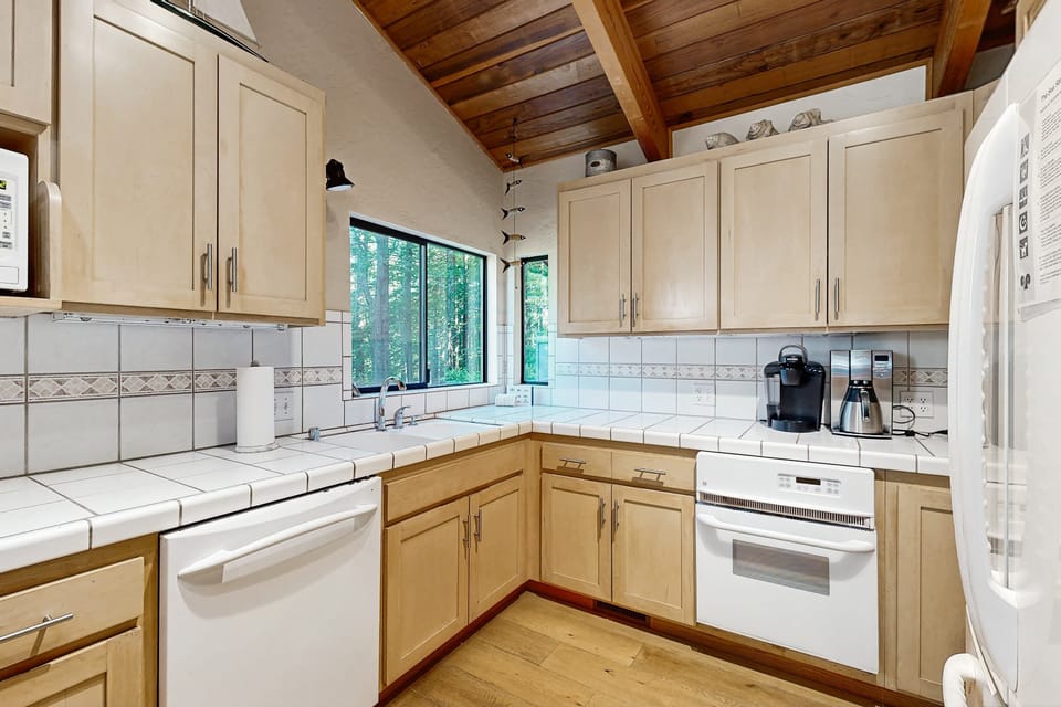 Start your mornings with fresh coffee brewed in this charming kitchen, where sunlight streams in to inspire your day.