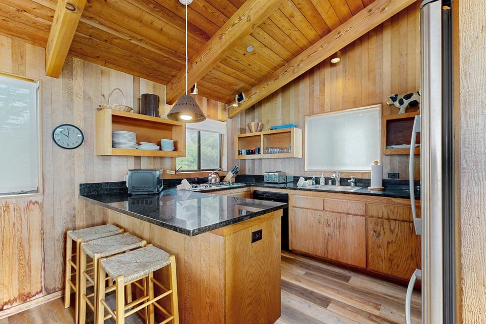 Craft culinary delights in this well-appointed kitchen, featuring modern appliances and ample counter space for your favorite recipes.