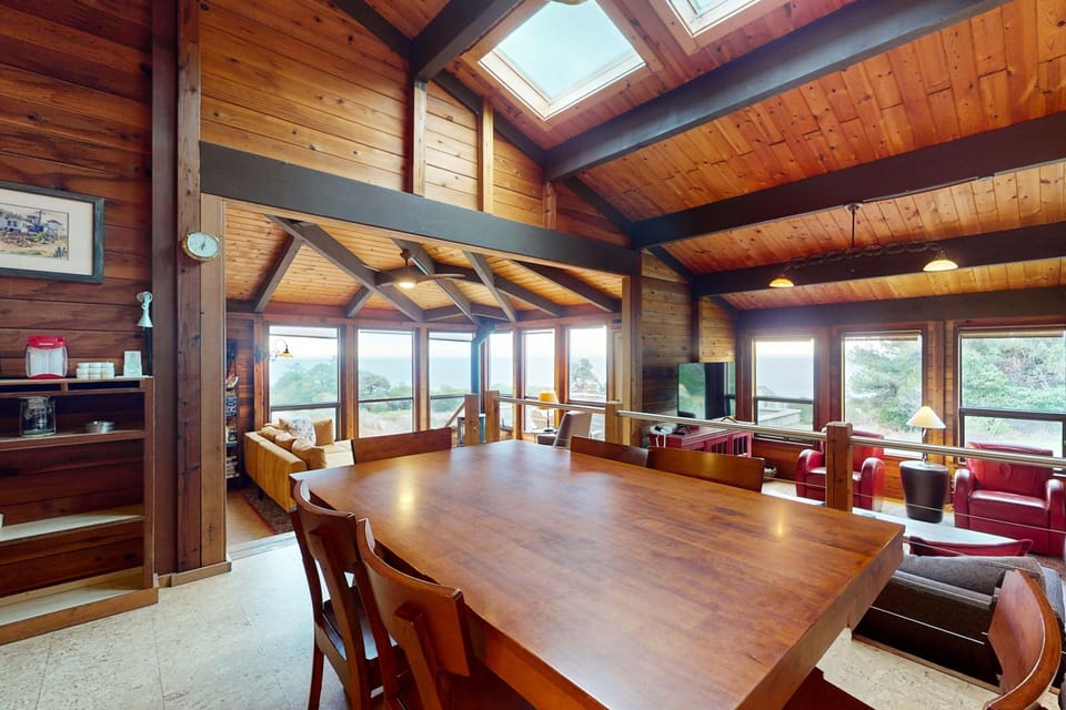 Savor delightful meals and laughter at this spacious dining table, where every gathering is enhanced by stunning ocean views.