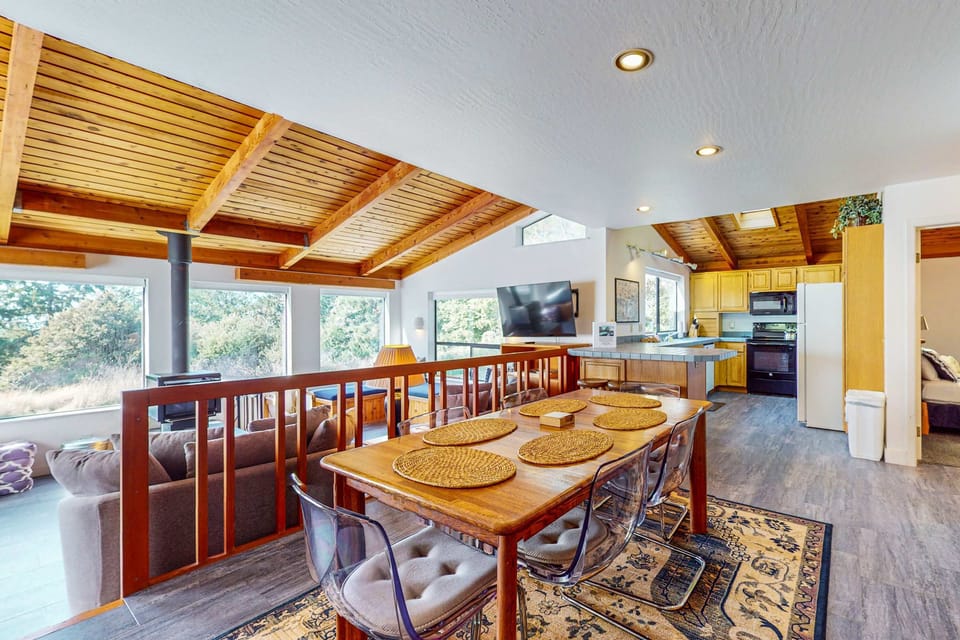Feel at home in the spacious living area, where the wood-beamed ceiling and cozy ambiance make every moment special.