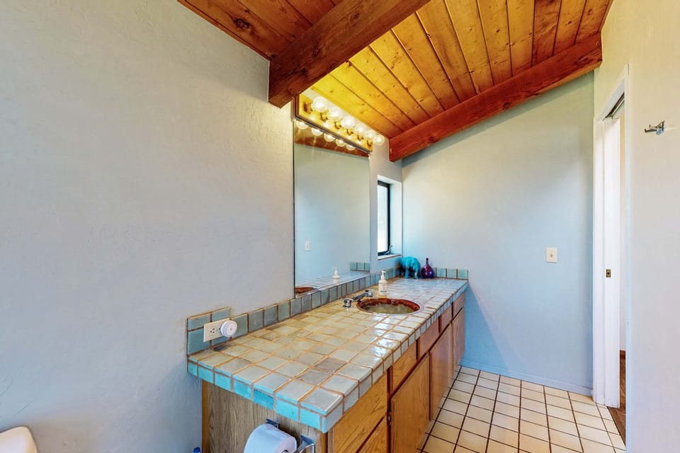 Enjoy the convenience of a thoughtfully designed bathroom, where natural light enhances your morning routine in a serene atmosphere.