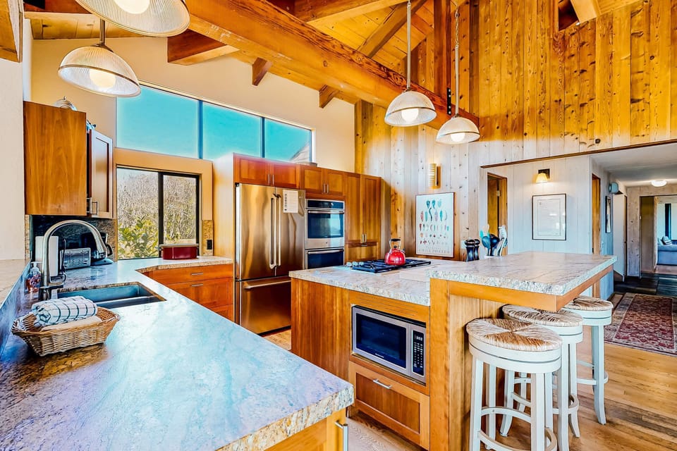 Whip up culinary masterpieces in the bright, spacious kitchen, featuring modern appliances and stunning views that inspire your cooking.