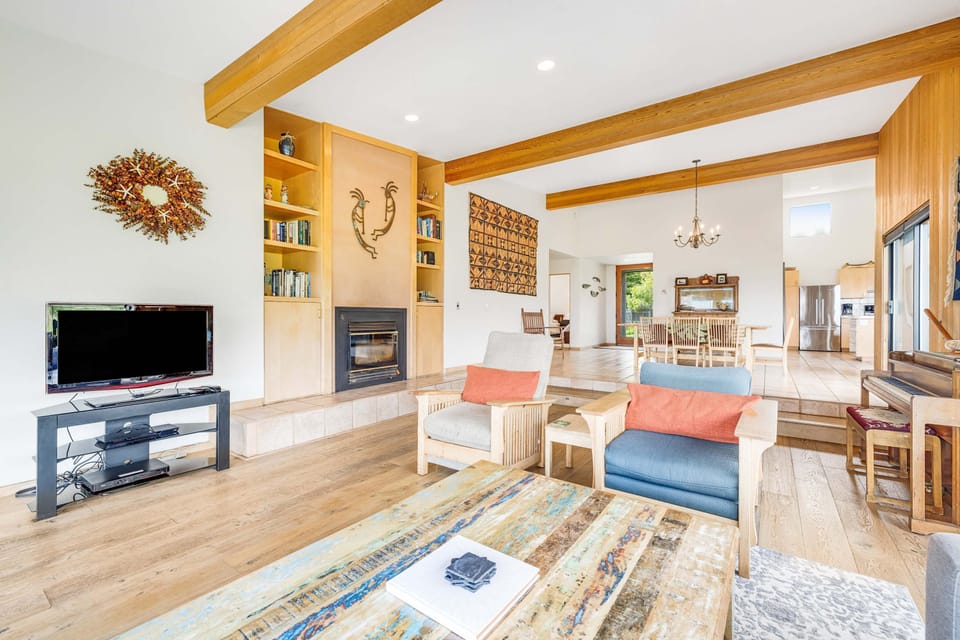 Cozy up in this inviting living room, where expansive windows frame the ocean views, creating a perfect backdrop for your relaxation.