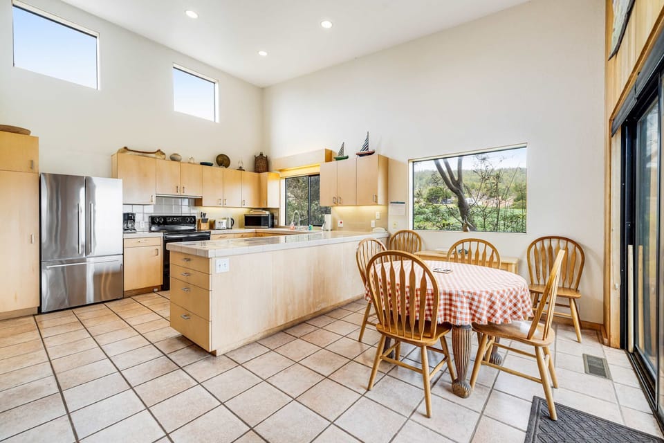 Whip up culinary delights in this spacious kitchen, where abundant natural light and ocean views inspire your creativity.