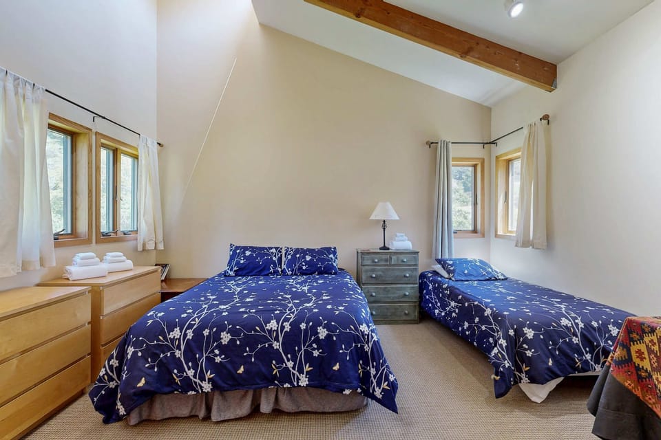 Thoughtfully designed, this bedroom offers flexibility, perfect for families or friends seeking comfort and relaxation in a tranquil setting.