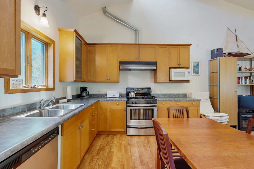 This well-appointed kitchen offers both functionality and warmth, making it the heart of your Sea Ranch retreat.
