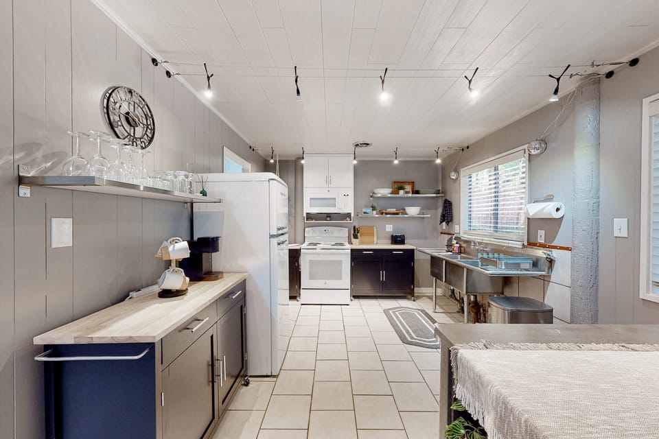 The spacious kitchen is ready for your culinary adventures, featuring modern amenities and a welcoming vibe.
