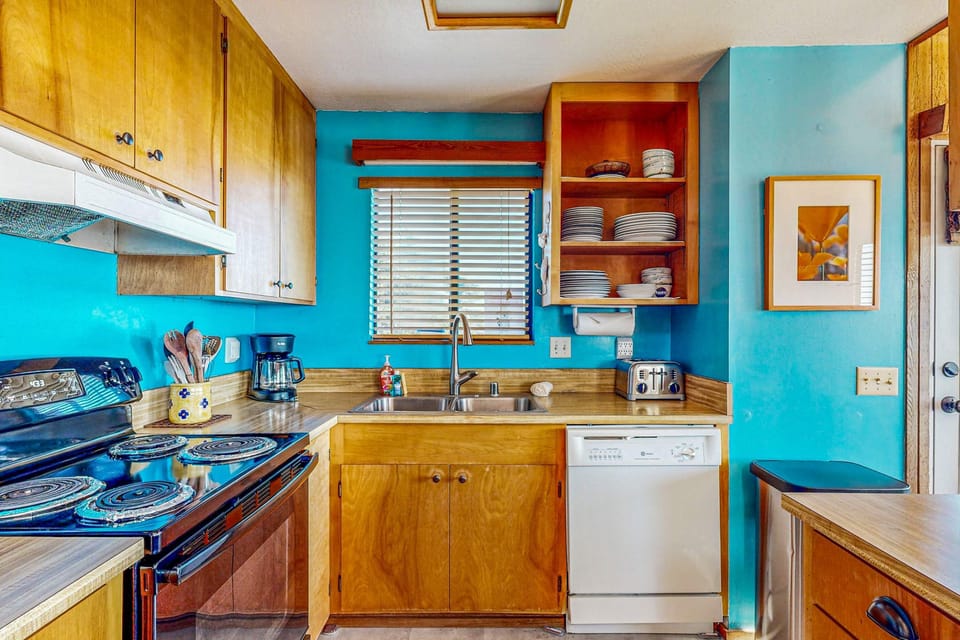 This thoughtfully designed kitchen blends functionality with style, making it the ideal space for preparing meals or enjoying a casual breakfast at the bar.