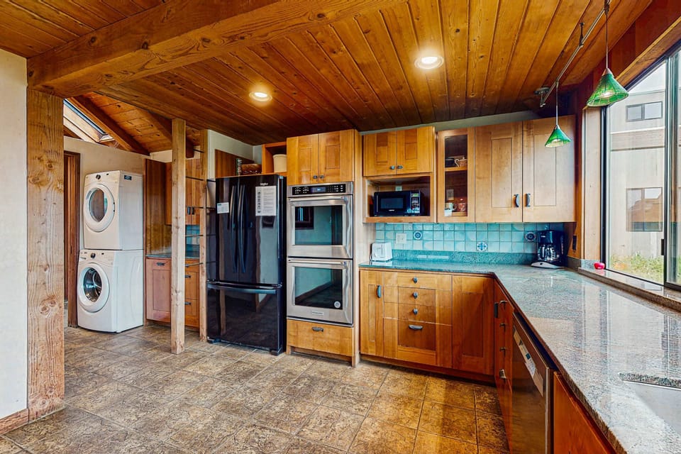 Enjoy the convenience of a thoughtfully designed kitchen, complete with ample counter space and large windows that fill the room with light.