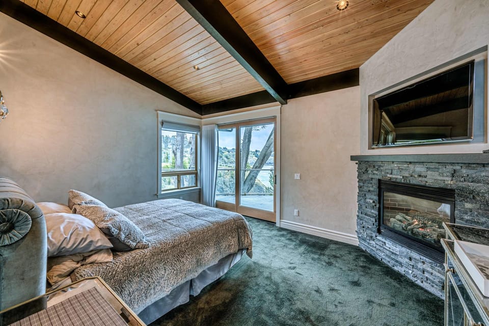 Retreat to the tranquil master bedroom, featuring a gas fireplace and views that promise restful nights and rejuvenating mornings.