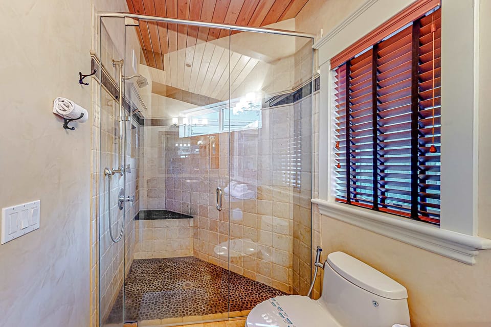 Step into a luxurious bathroom featuring a spacious walk-in shower, designed for rejuvenation after a day of adventure.