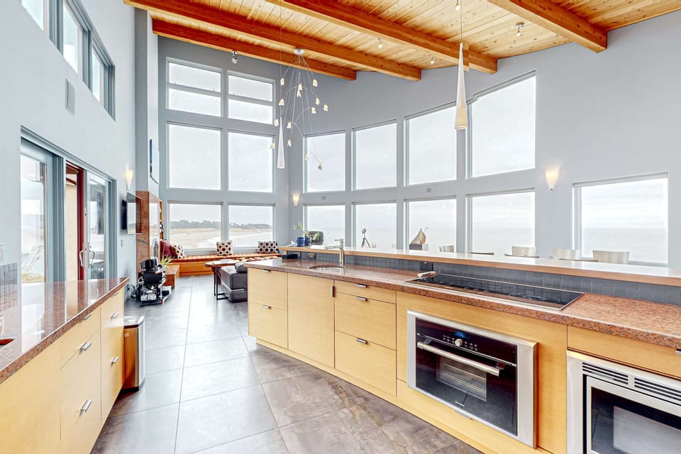 Natural light fills the kitchen, enhancing your cooking experience while you enjoy the beauty of the coastal landscape just outside.