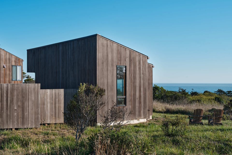 Step into serenity as you approach Wild Meadow, where modern design meets the beauty of nature, just a stone's throw from the ocean.