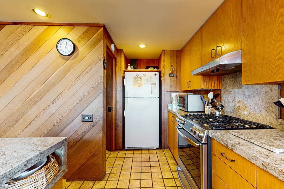 Craft delightful dishes in this inviting kitchen, designed for both functionality and soaking in the coastal atmosphere.