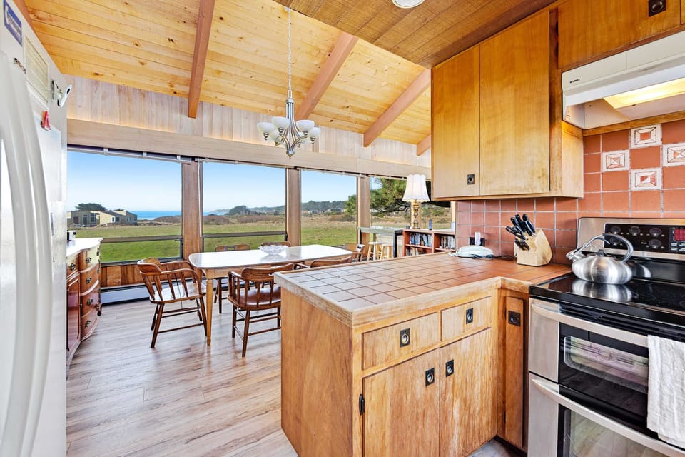 Gather around the spacious island in this kitchen, perfect for casual chats and quick meals while enjoying the beauty of Sea Ranch.