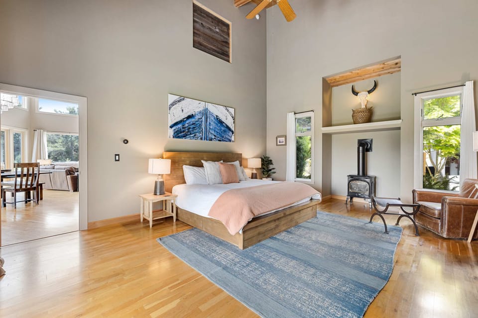 Awaken to gentle morning light in the master bedroom, complete with a cozy seating area perfect for quiet moments.