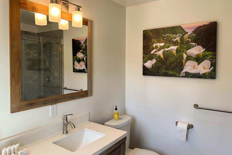 This tranquil bathroom features elegant decor, inviting you to unwind after a day of adventure on the coast.