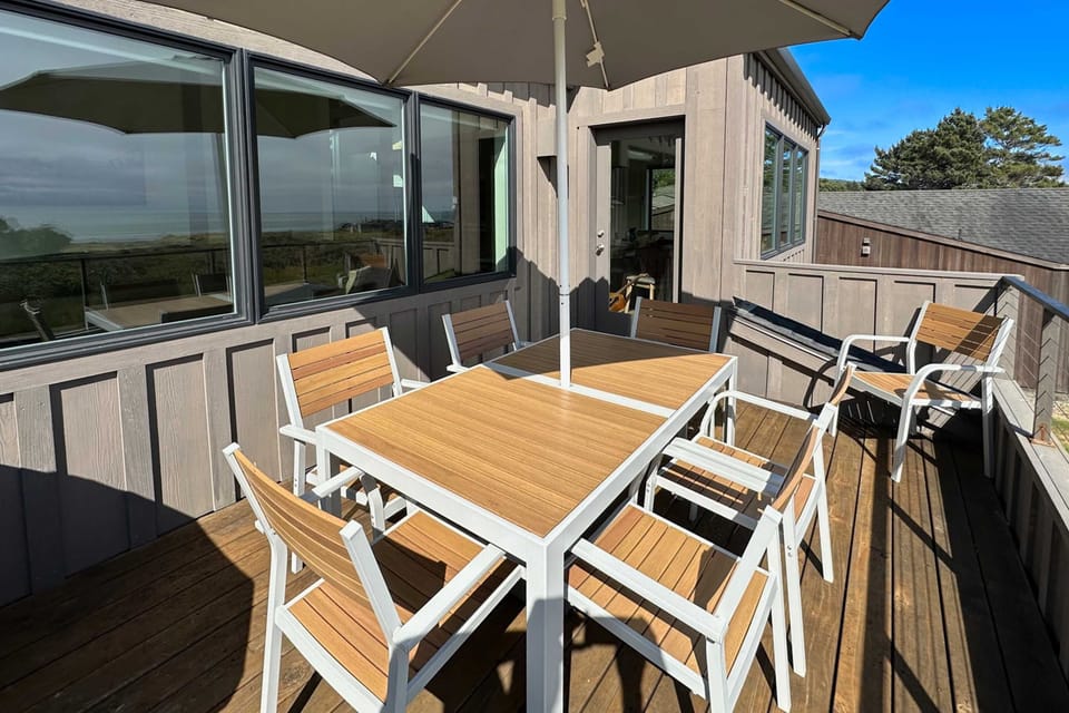 Gather around the outdoor dining table, where meals become memorable experiences against the backdrop of coastal serenity.