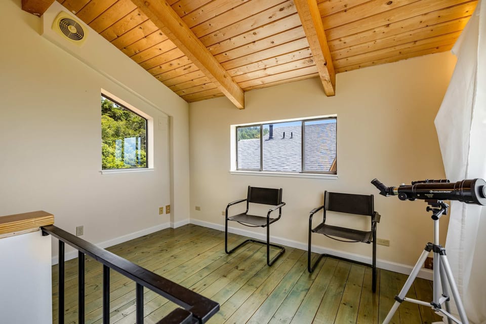 Picture yourself in this serene study nook, perfect for quiet contemplation or planning your next coastal excursion with a telescope at hand.