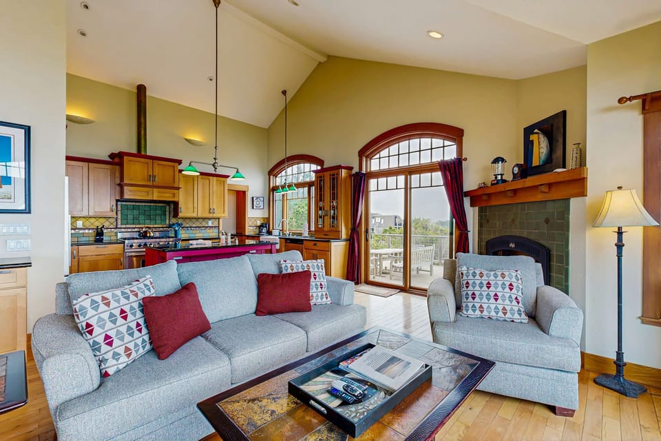 Gather in the cozy living area, where modern comforts blend with coastal elegance, perfect for family movie nights or quiet reading.