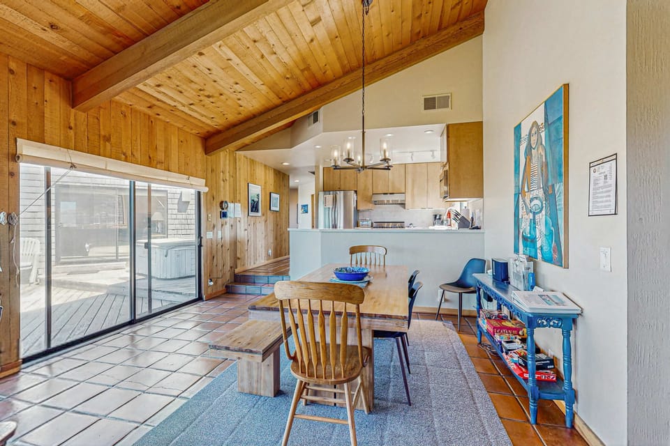 Picture your morning coffee shared at this dining table, with sunlight streaming through the windows, connecting you to the outdoors.