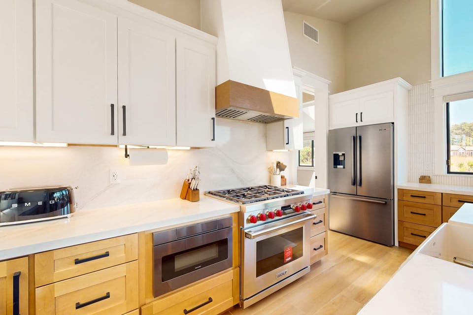 Modern appliances meet coastal charm in this spacious kitchen, designed for effortless meal prep and family gatherings.