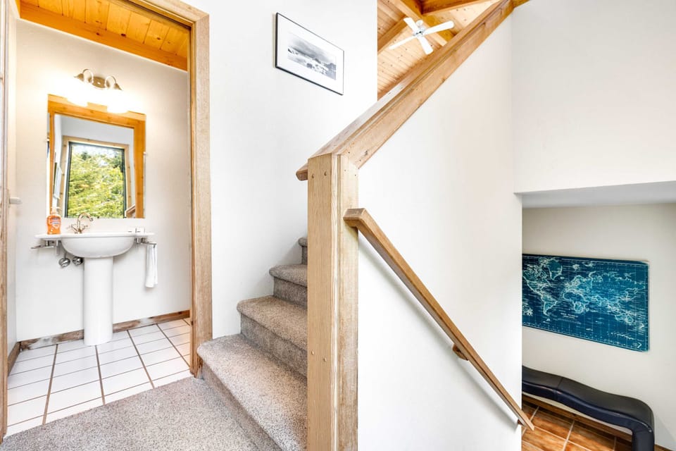 Step into this inviting bathroom, thoughtfully placed near the bedrooms for easy access and a touch of comfort during your stay.