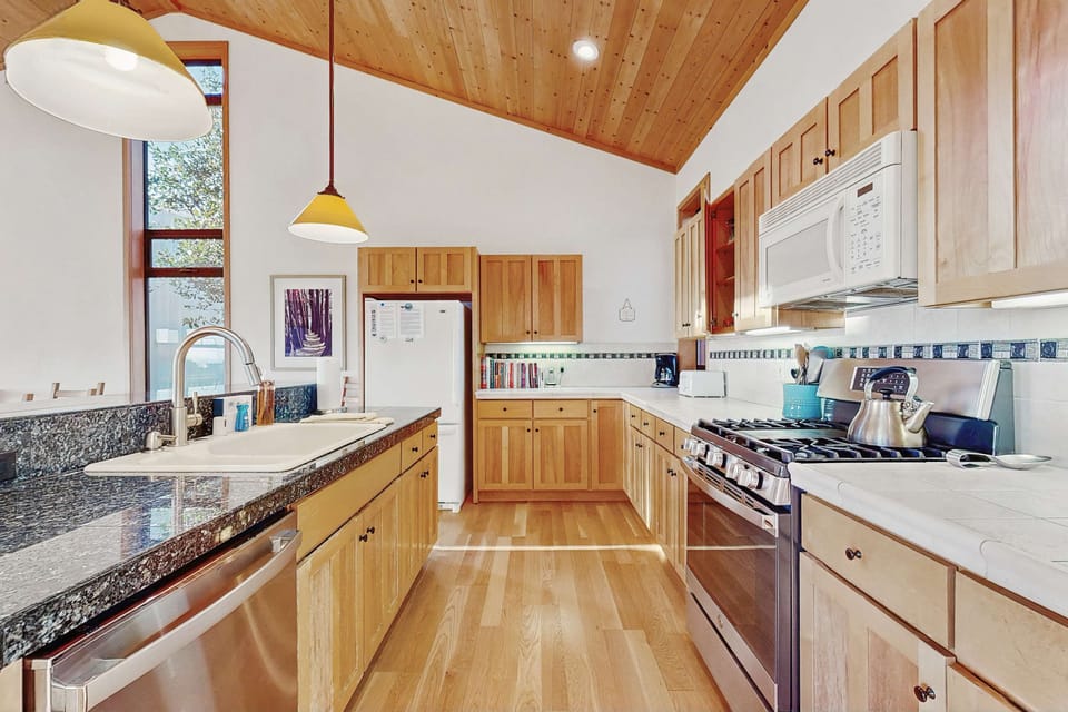 Natural light streams through the windows, creating a warm and inviting atmosphere as you prepare meals or share a morning coffee.