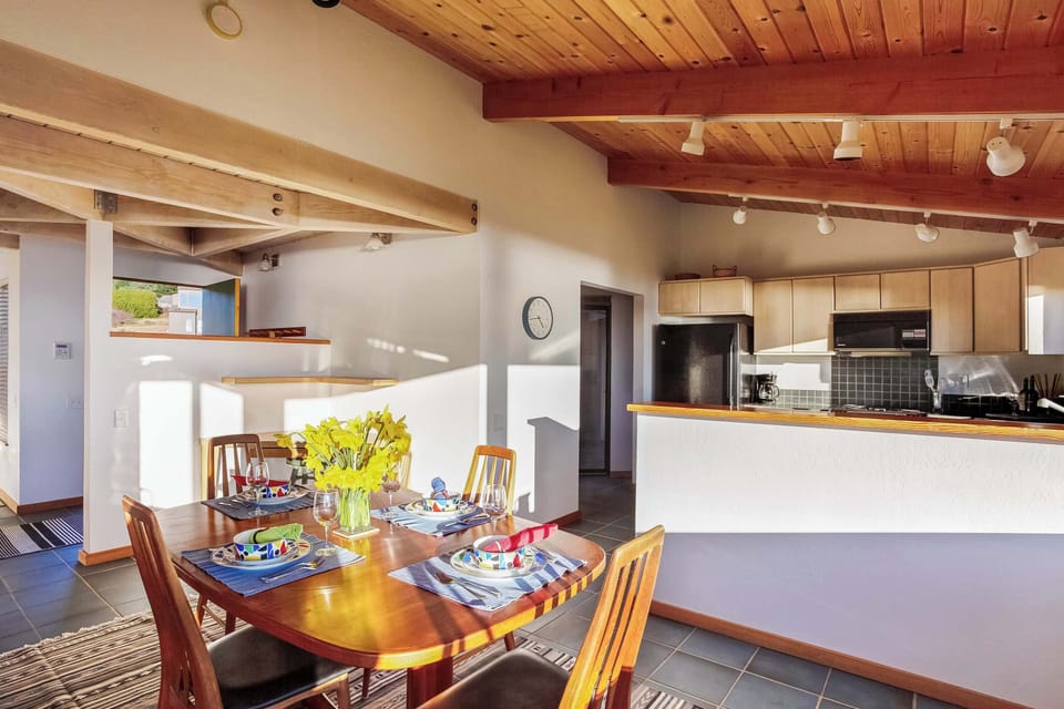 Gather around the dining table for memorable meals, where the bright ambiance and ocean views make every bite a delight.