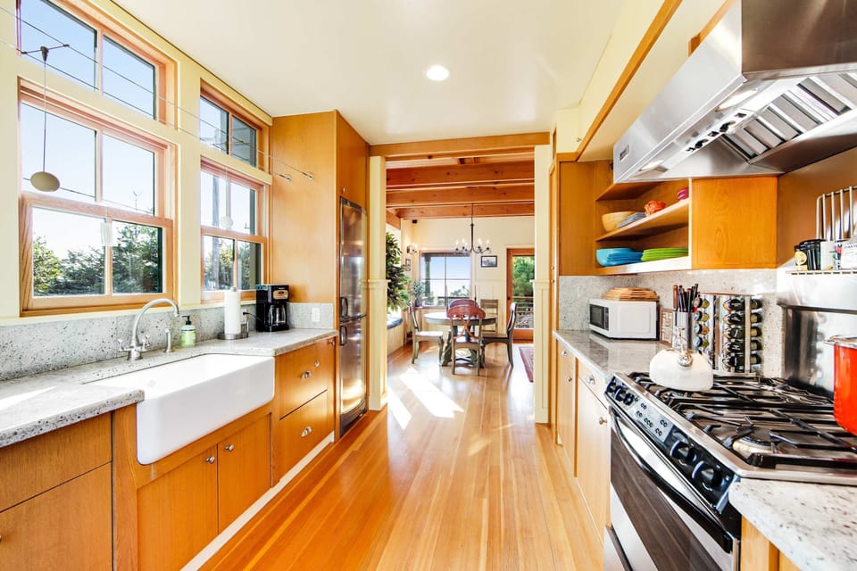 Let your culinary creativity flourish in this bright kitchen, where natural light and modern appliances inspire delicious meals.