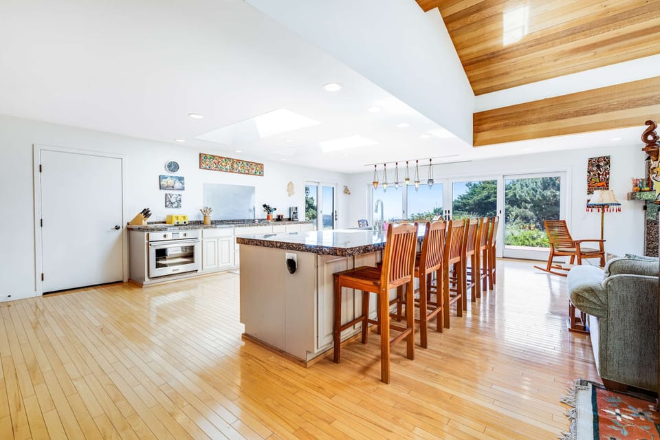 Gather around the island for casual breakfasts or late-night snacks in this open concept kitchen, where every moment feels special.