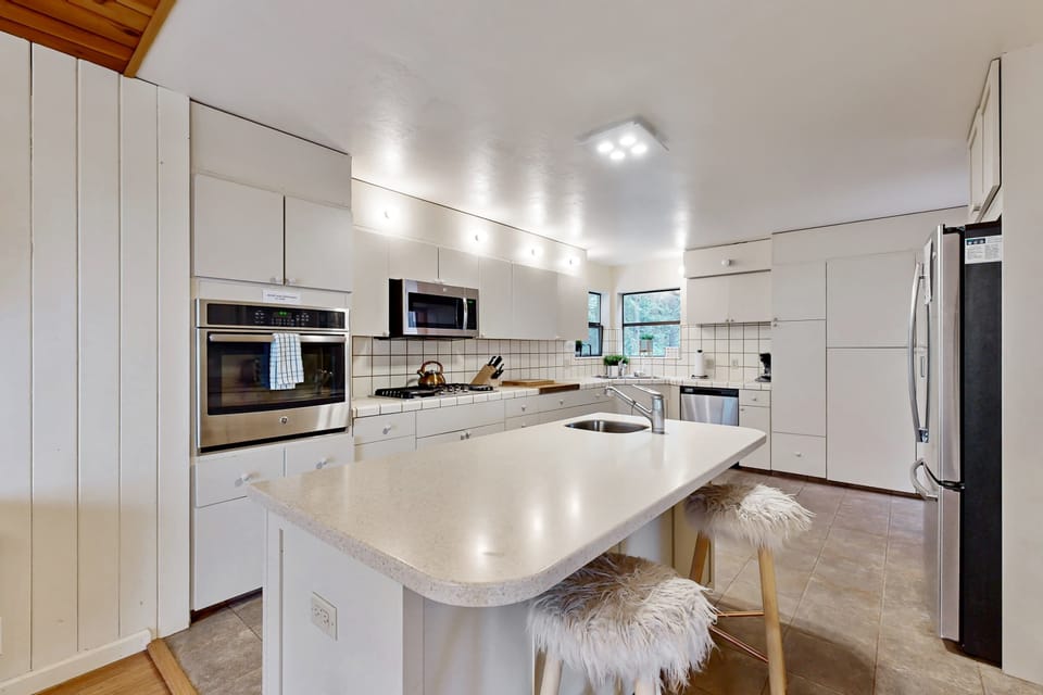 Cook up your favorite meals in this modern kitchen, designed for both functionality and style, making mealtime a delightful experience.