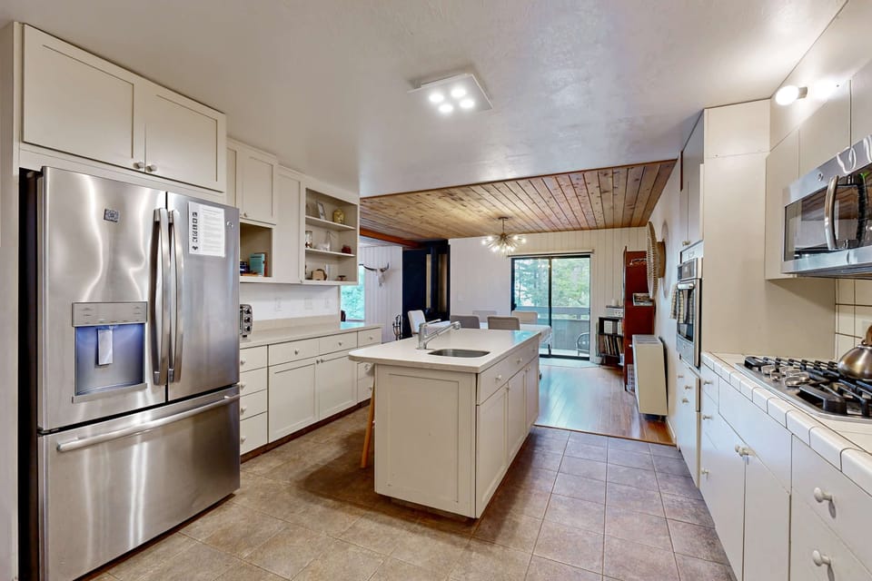 With ample counter space and top-notch appliances, this kitchen is your culinary playground, ready for family feasts and quick snacks alike.