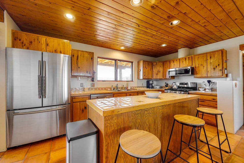 Cook in the updated kitchen with stainless appliances and a tiled island