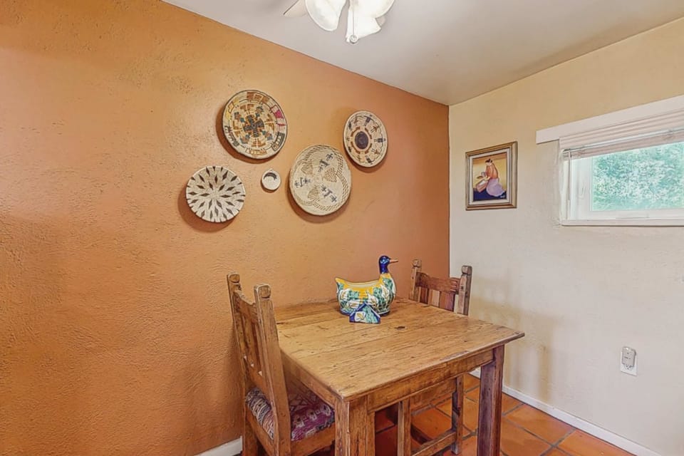 A cozy dining nook for two with Southwestern art