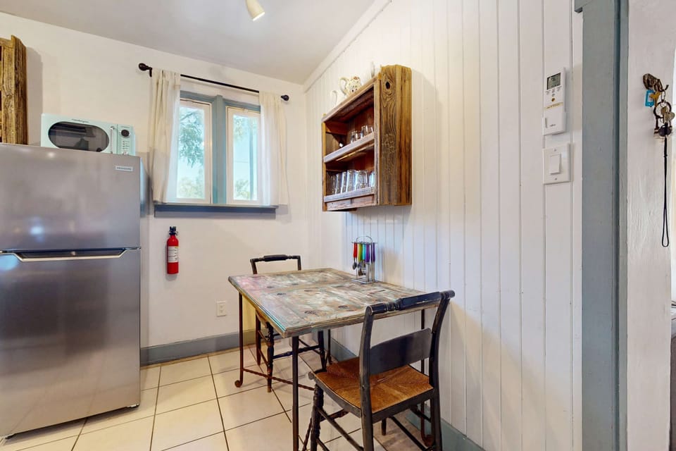 Find a full-size fridge and microwave in the well-equipped kitchen