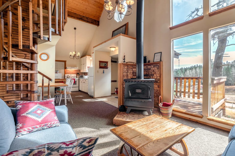 Open living and dining with a spiral stair to the loft