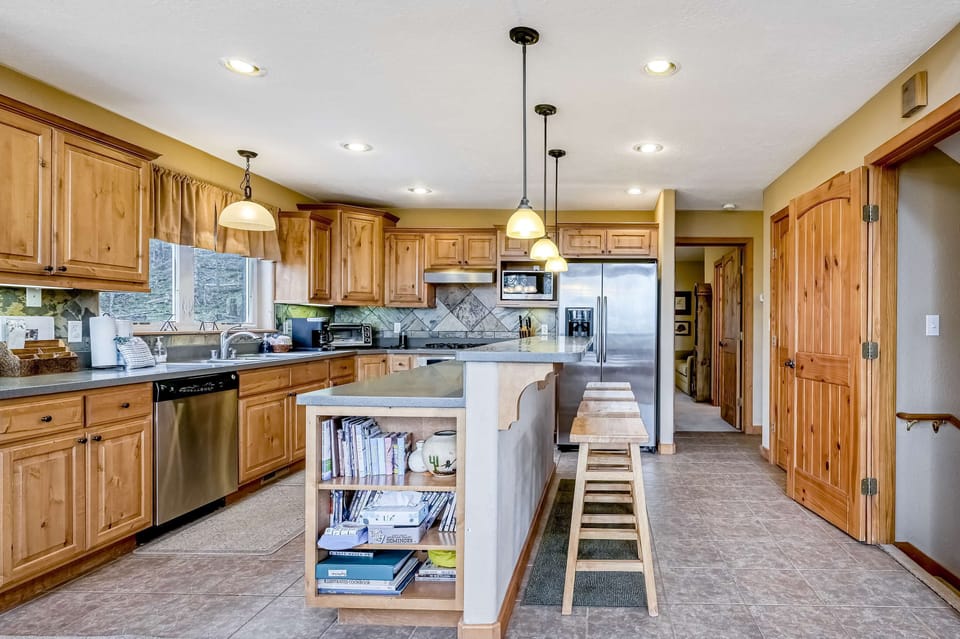 Cook with ease in the kitchen with stainless appliances and an island