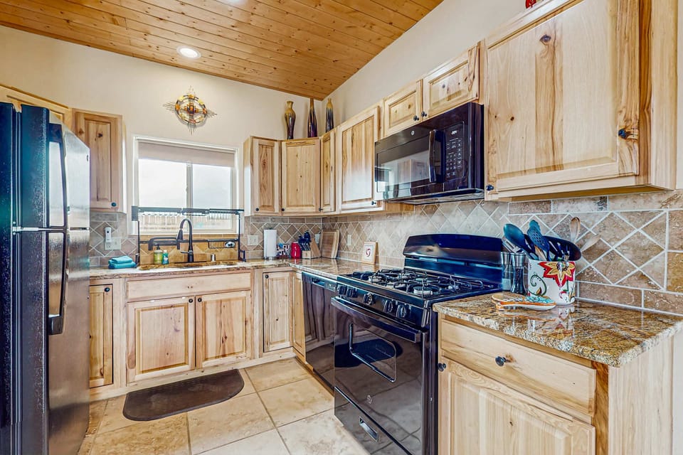 Find a dishwasher, gas range, and plenty of prep space in the kitchen