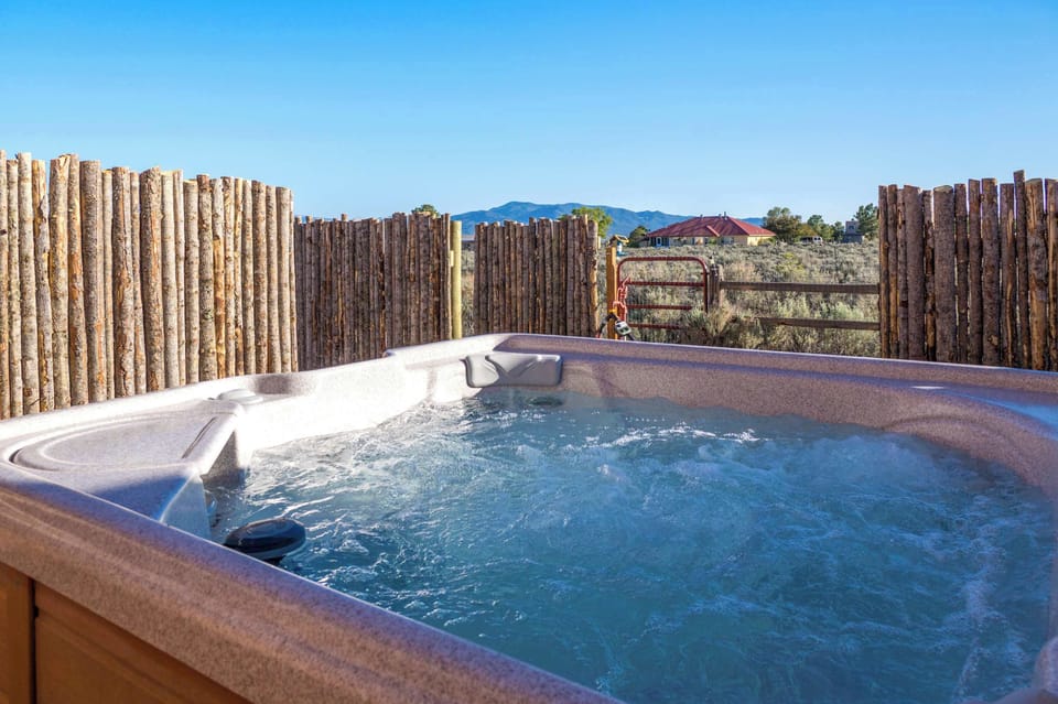 Sink into the private hot tub with mountain and valley views