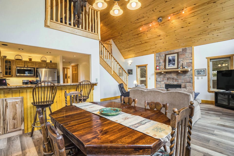 Dining opens to the kitchen and living room under the loft