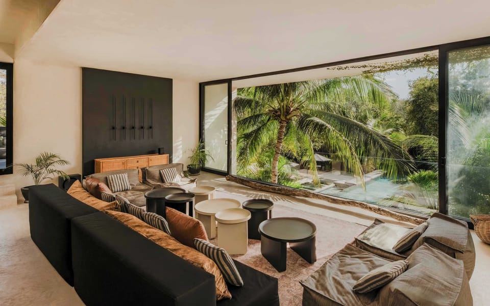 The living room opens right up to the pool and palm views.