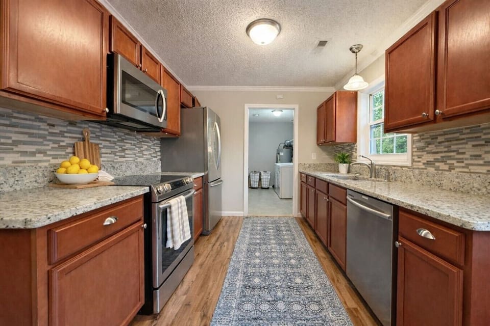 Fully equipped kitchen with modern appliances and plenty of counter space for preparing meals.