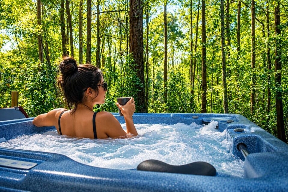 Relax and unwind in the private hot tub surrounded by peaceful wooded views.